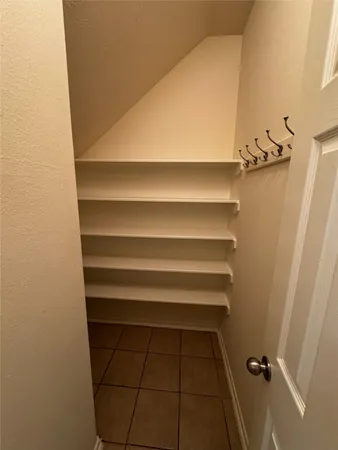 a view of walk in closet with empty racks