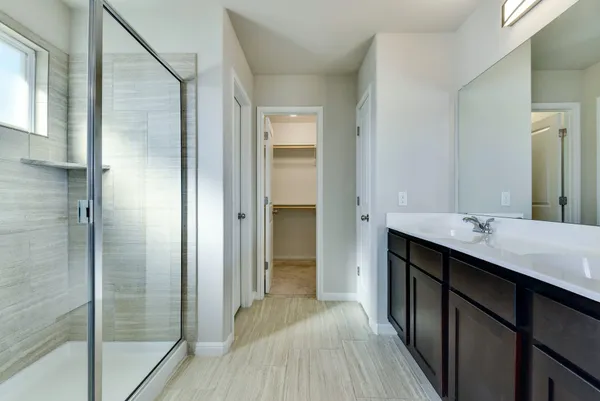 a bathroom with a double vanity sink and mirror