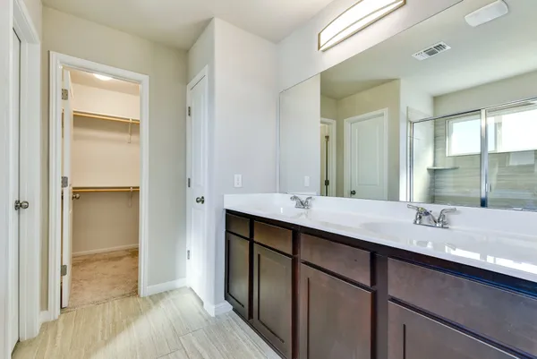 a bathroom with a sink double vanity and a mirror