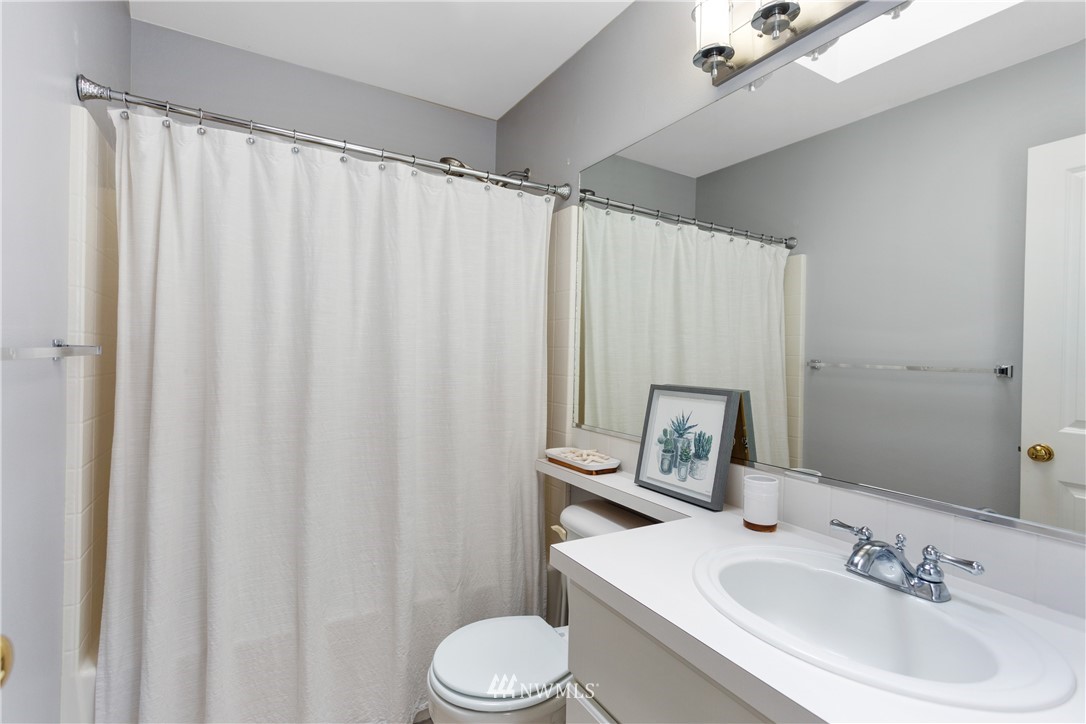529 Chelan Place Northeast Renton, WA 98059 - Photo 14 of 20 a bathroom with a sink a toilet and shower curtain