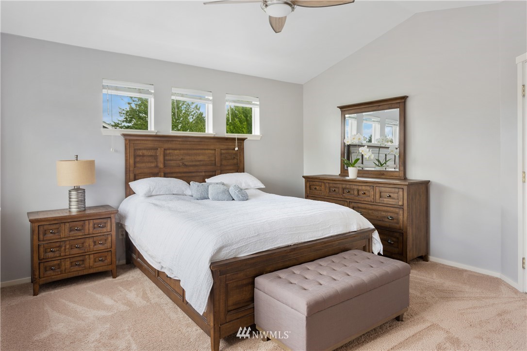 529 Chelan Place Northeast Renton, WA 98059 - Photo 15 of 20 a bedroom with a bed a couch and windows