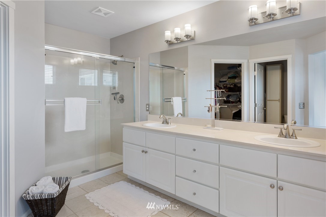 529 Chelan Place Northeast Renton, WA 98059 - Photo 16 of 20 a bathroom with a double vanity sink mirror and shower