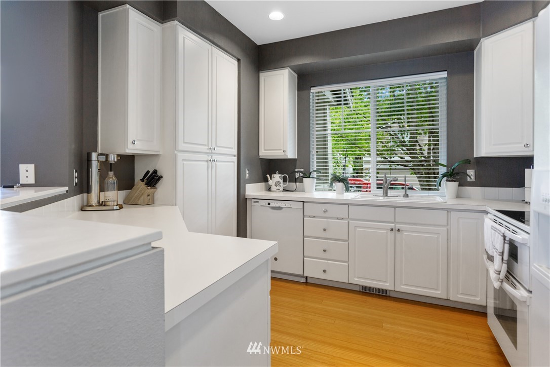 529 Chelan Place Northeast Renton, WA 98059 - Photo 7 of 20 a kitchen with white cabinets and a window