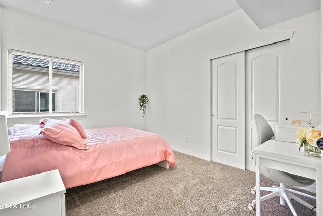 a bedroom with a bed and chair