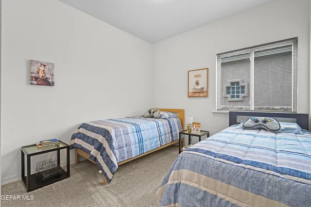 a bedroom with two beds and a window