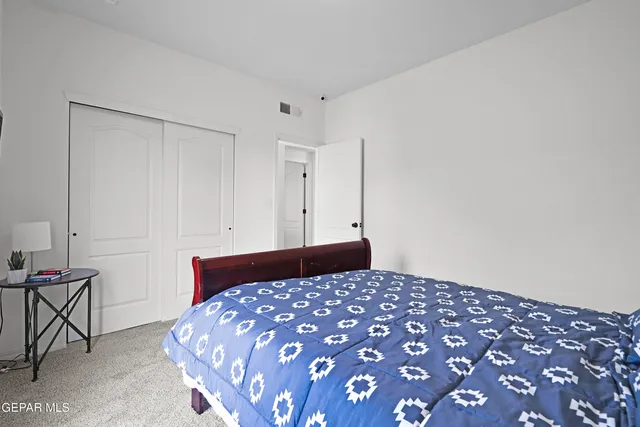 a bedroom with a bed and a table