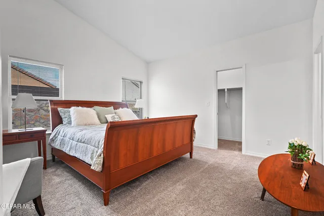 a bedroom with a bed and window