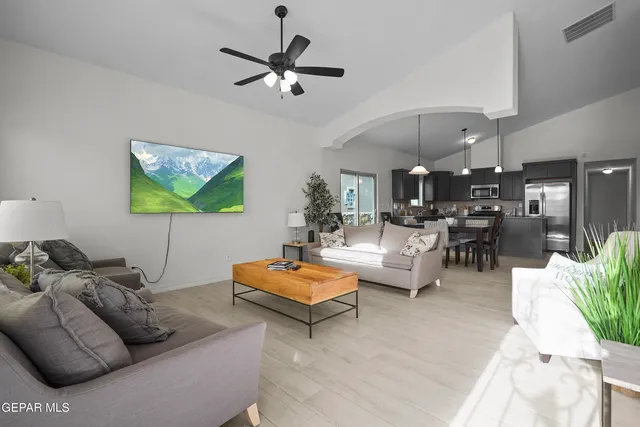 a living room with furniture and a chandelier
