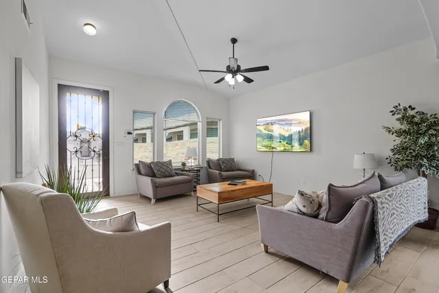 a living room with furniture and a chandelier