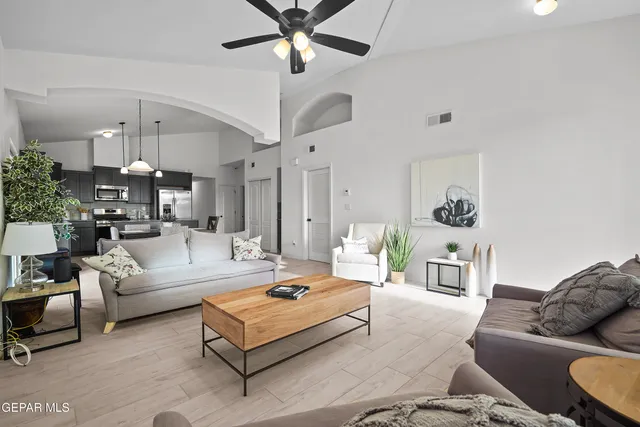 a living room with furniture and a chandelier