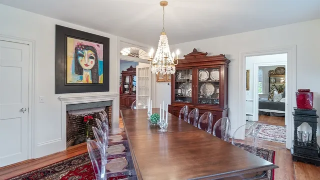 a view of a dining room with furniture a chandelier and wooden floor