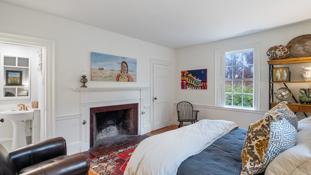 239 High Road Newbury, MA 01951 - Photo 16 of 42 a bedroom with a bed and a fireplace