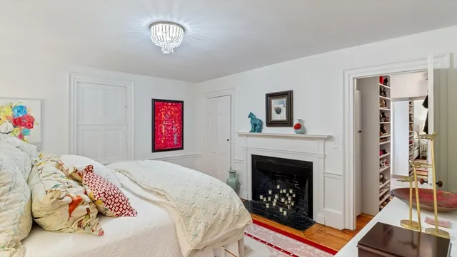 a bedroom with a bed and a fireplace