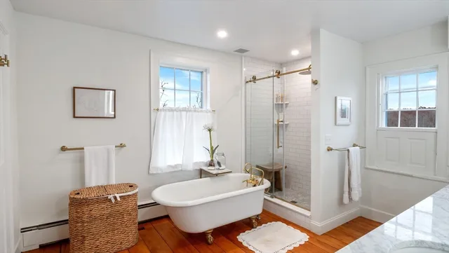 a bathroom with a double vanity sink mirror and shower