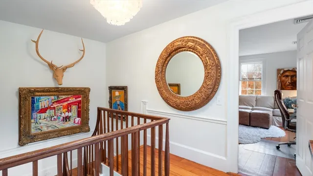 a living room with furniture a mirror and a window