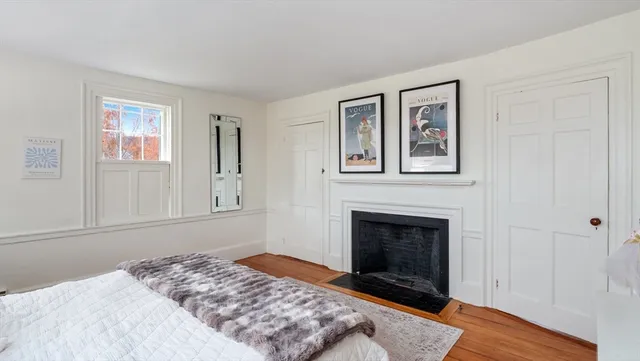 a bedroom with a bed and a fireplace