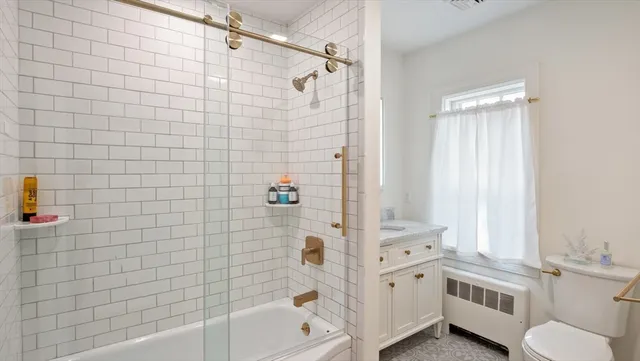 a bathroom with a bathtub a toilet and a shower