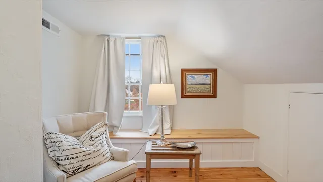a living room with furniture and a lamp