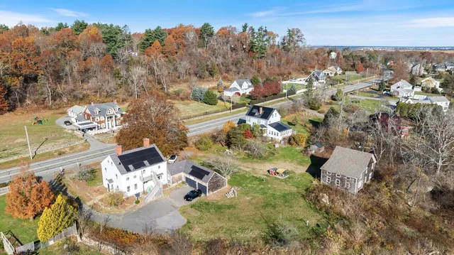 an aerial view of a house with a yard
