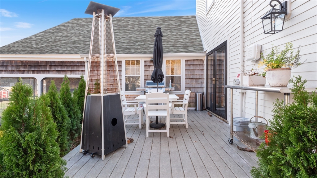 239 High Road Newbury, MA 01951 - Photo 5 of 42 a view of a patio with table and chairs and potted plants