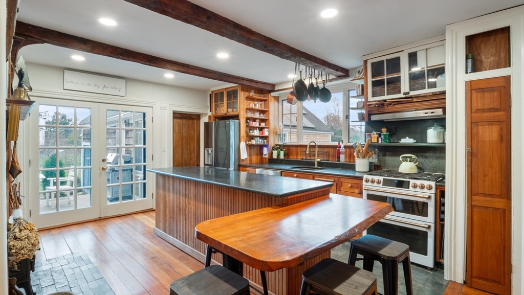 239 High Road Newbury, MA 01951 - Photo 6 of 42 a room with wooden floor table and chairs