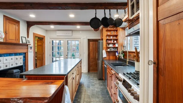 a kitchen with stainless steel appliances granite countertop a stove and a refrigerator