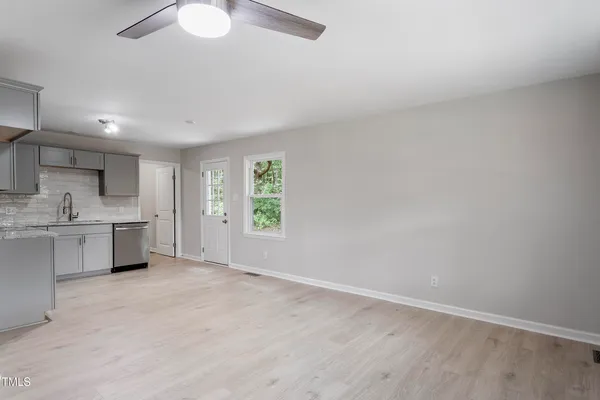 a view of kitchen with stove and cabinets
