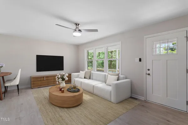 a living room with furniture and a flat screen tv