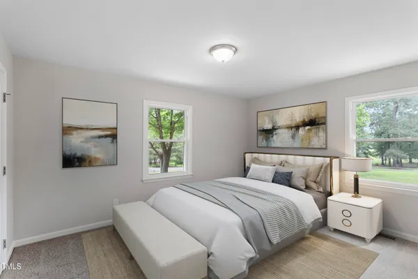 a bedroom with a large bed and a window