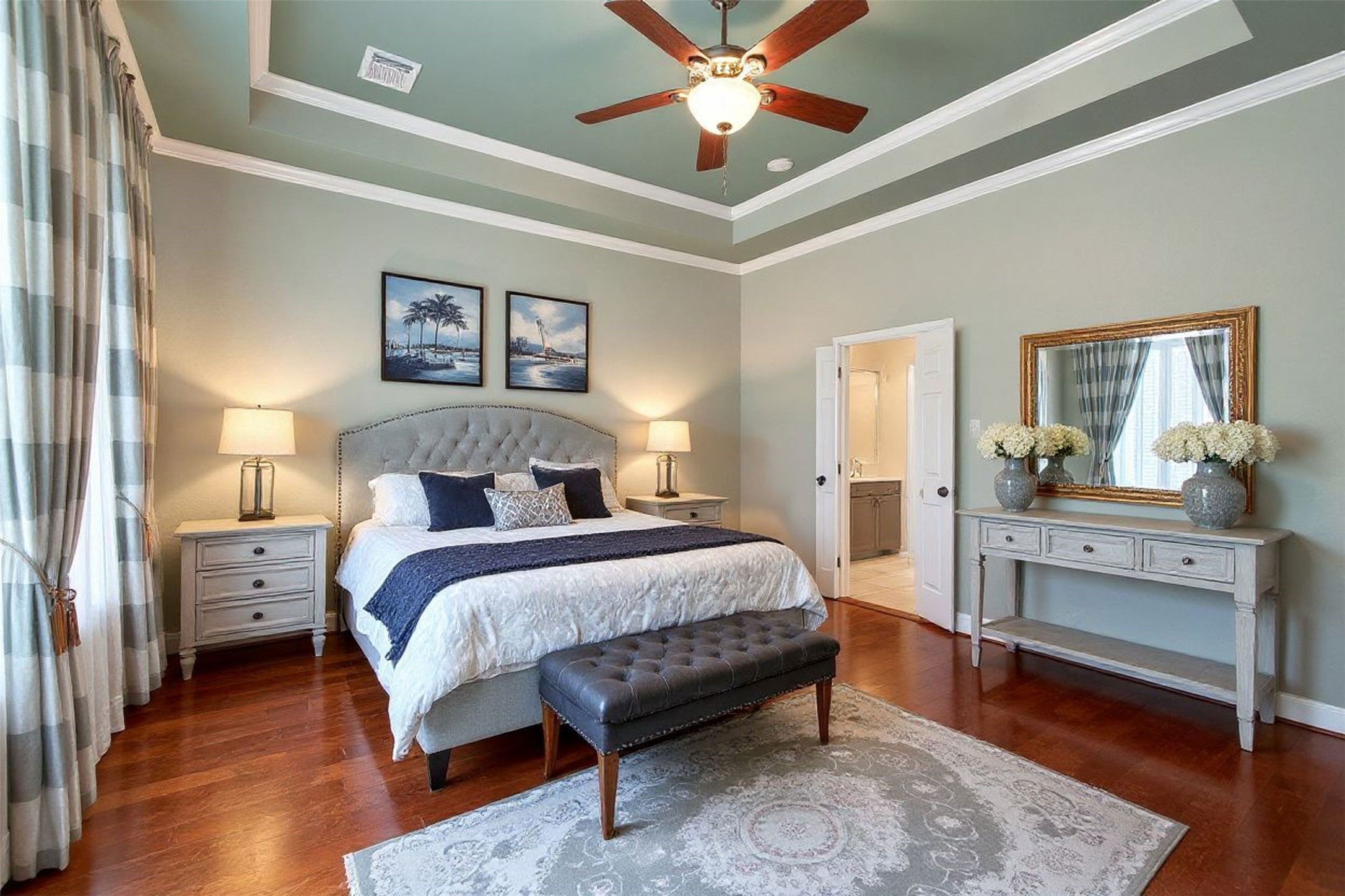 15614 Stable Brook Circle Cypress, TX 77429 - Photo 15 of 48 Staged primary bedroom with wall to wall windows and window covering.