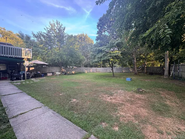 a living room with furniture a flat screen tv and a window