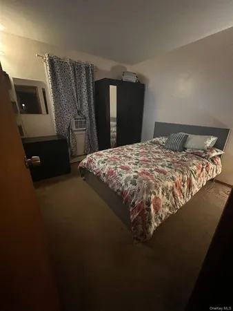 a bedroom with a bed and dresser