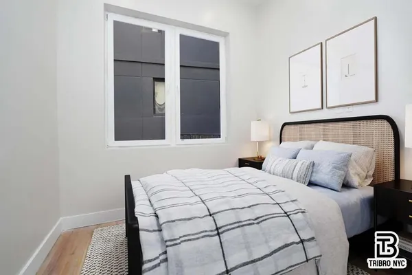 a bedroom with a bed and cabinets