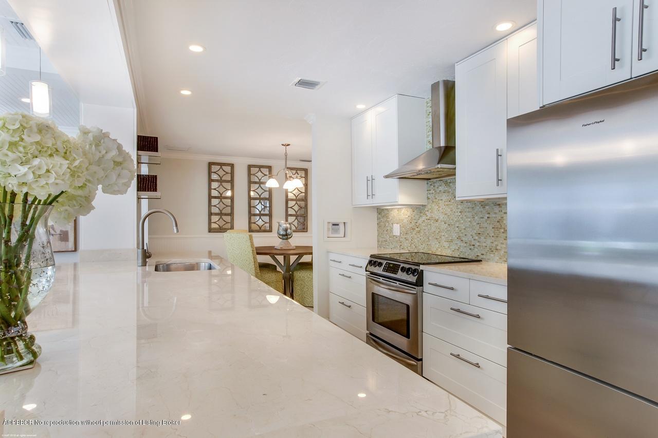 11 Ridge Boulevard Ocean Ridge, FL 33435 - Photo 13 of 26 a kitchen with stainless steel appliances granite countertop a stove a sink and a refrigerator