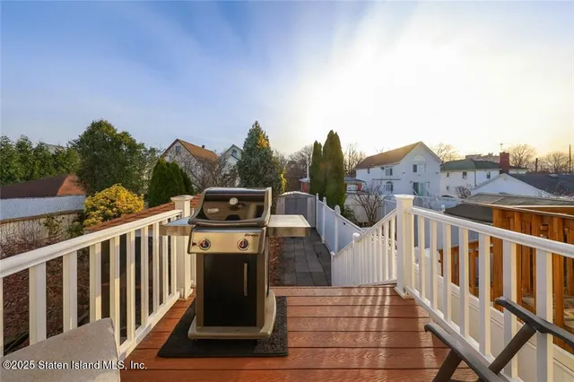 a view of a balcony with wooden fence and floor