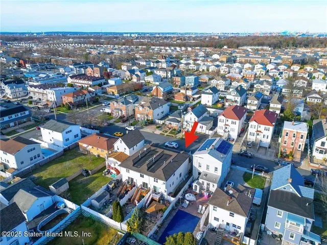 an aerial view of a house with a lake view