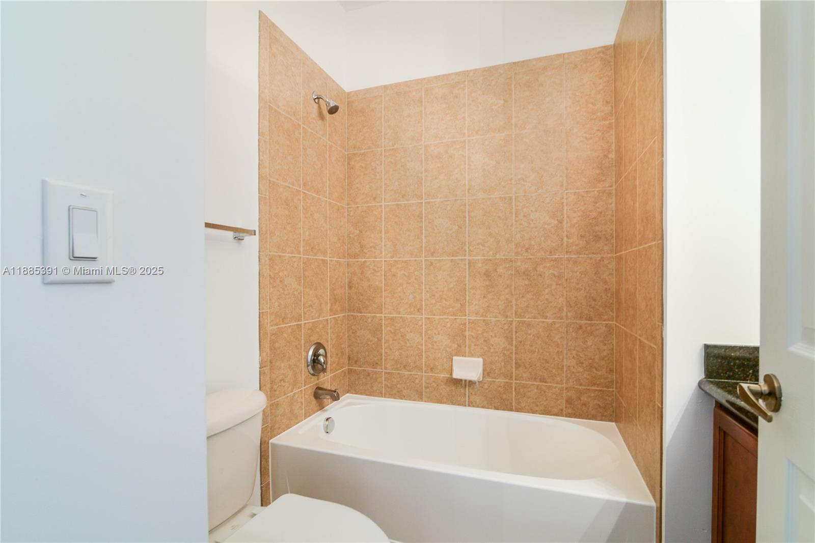 1108 Southwest 146th Terrace Pembroke Pines, FL 33027 - Photo 14 of 14 a bathroom with a bathtub and a toilet