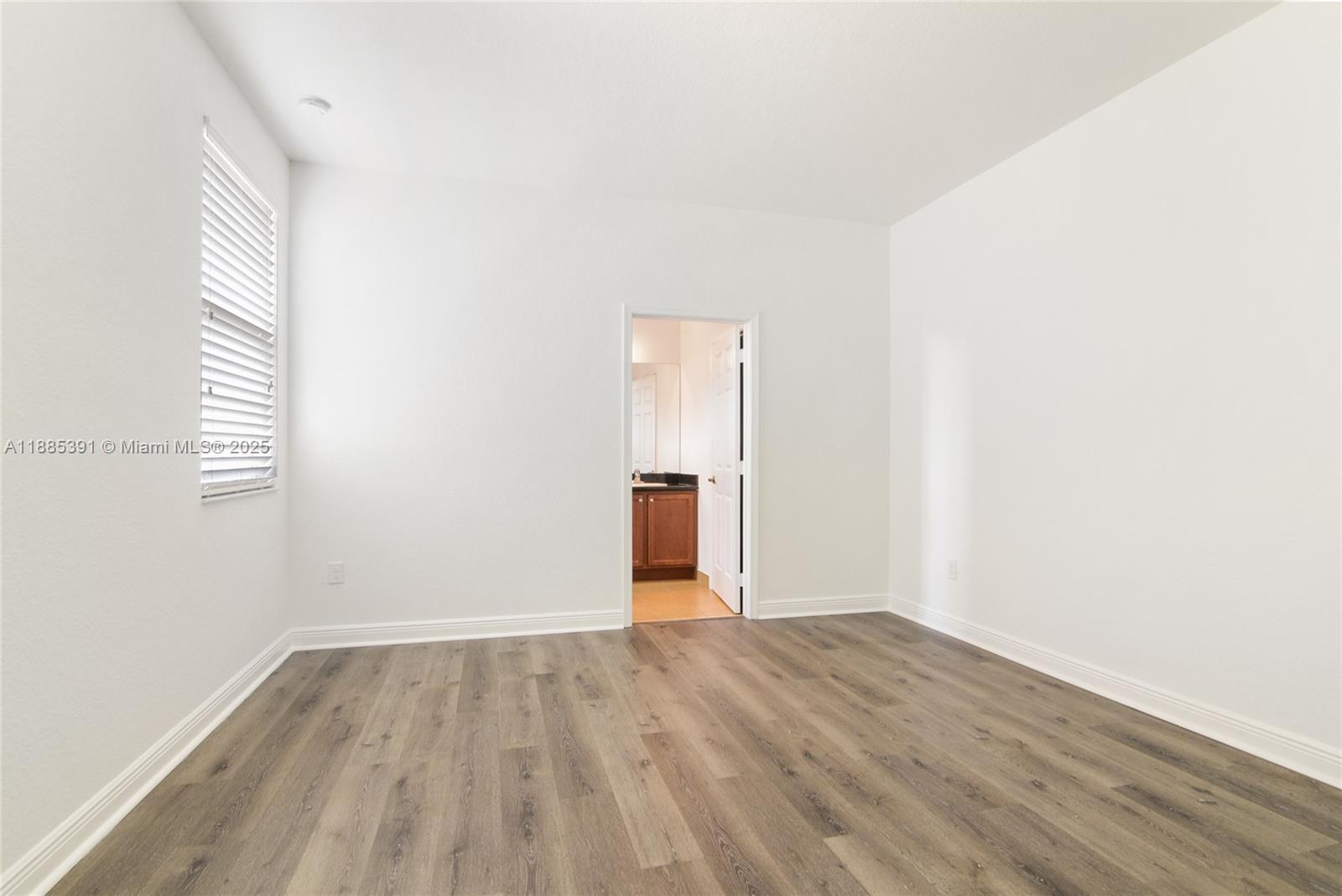 1108 Southwest 146th Terrace Pembroke Pines, FL 33027 - Photo 8 of 14 a view of empty room with wooden floor