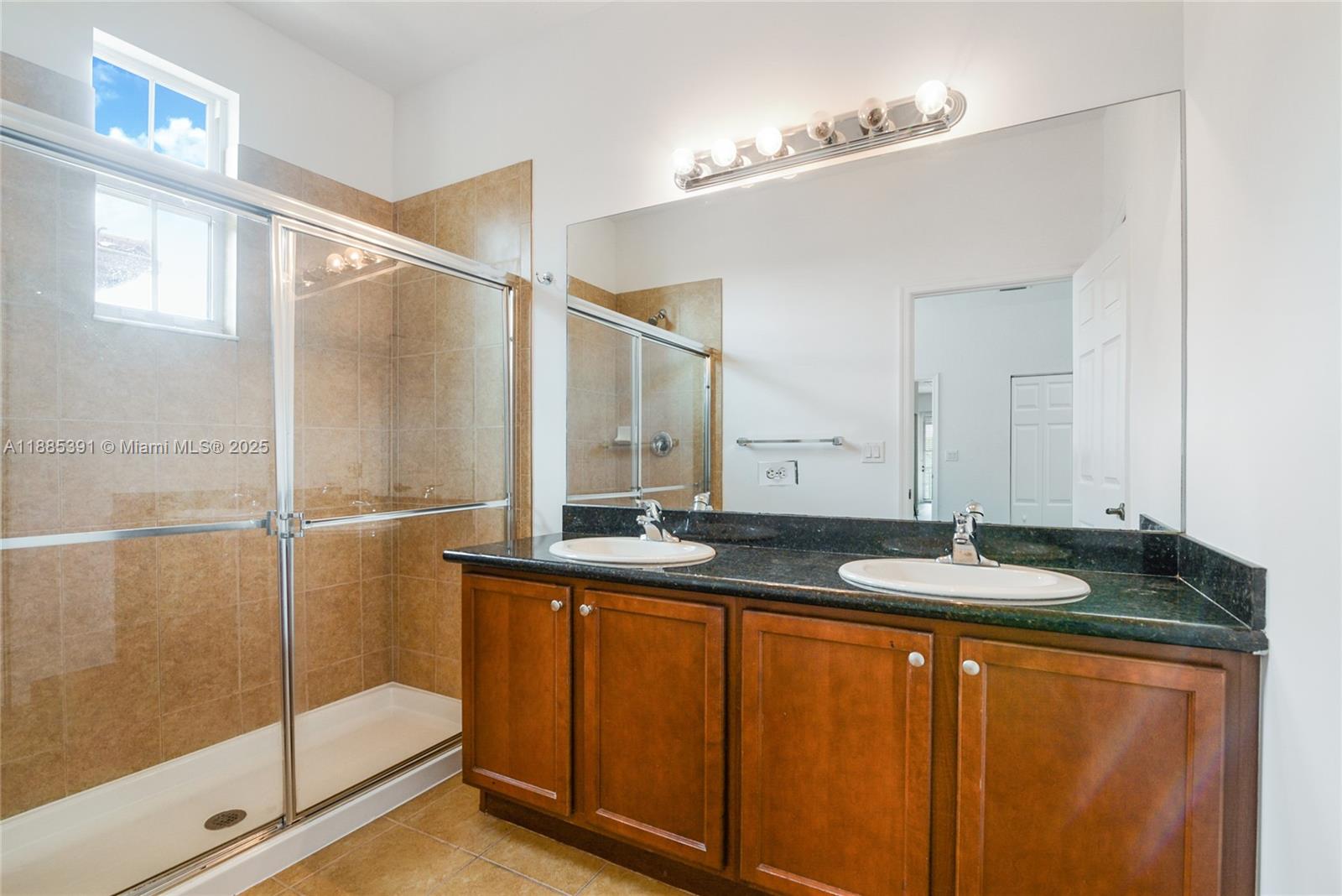 1108 Southwest 146th Terrace Pembroke Pines, FL 33027 - Photo 9 of 14 a bathroom with a granite countertop sink and a mirror