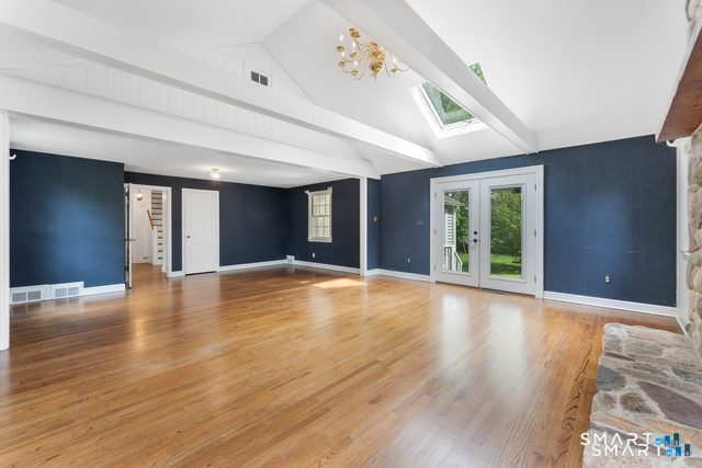 62 Chatham Road Berlin, CT 06037 - Photo 13 of 38 a view of an empty room with window and wooden floor