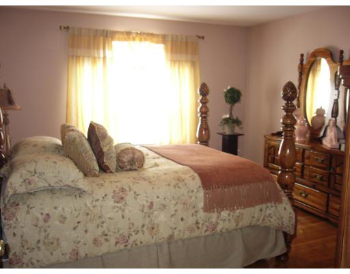 206 Manchester Street Fall River, MA 02721 - Photo 2 of 12 a bedroom with a bed and wooden floor