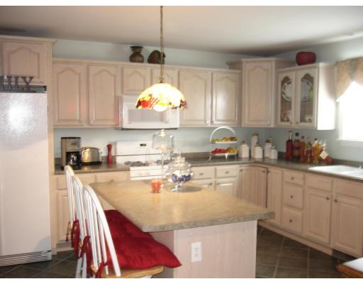 206 Manchester Street Fall River, MA 02721 - Photo 9 of 12 a kitchen with kitchen island granite countertop a stove a sink and a refrigerator