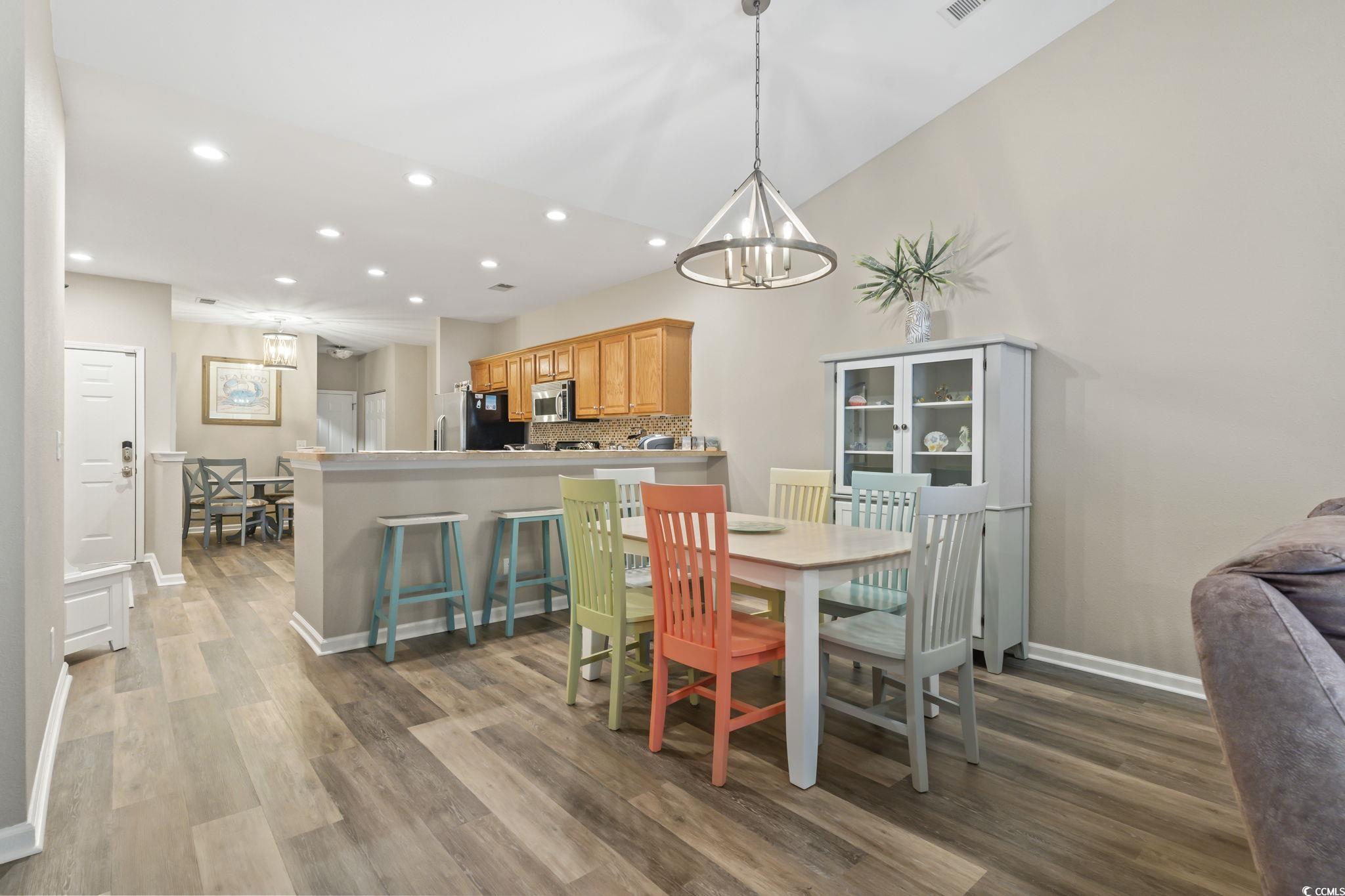 430 Woodpecker Lane, Unit D Murrells Inlet, SC 29576 - Photo 11 of 36 Dining space with recessed lighting, a chandelier, and dark wood finished floors