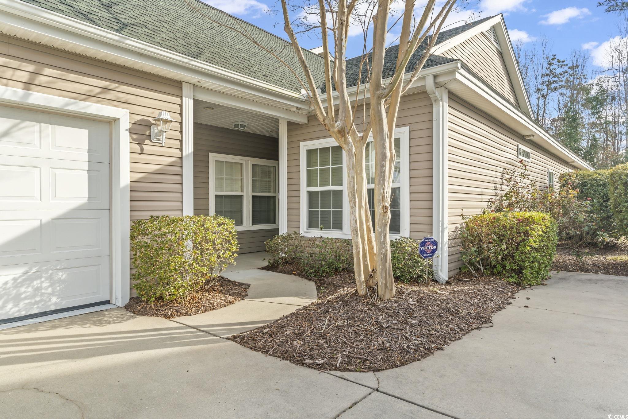 430 Woodpecker Lane, Unit D Murrells Inlet, SC 29576 - Photo 2 of 36 Property entrance with a shingled roof and a garage