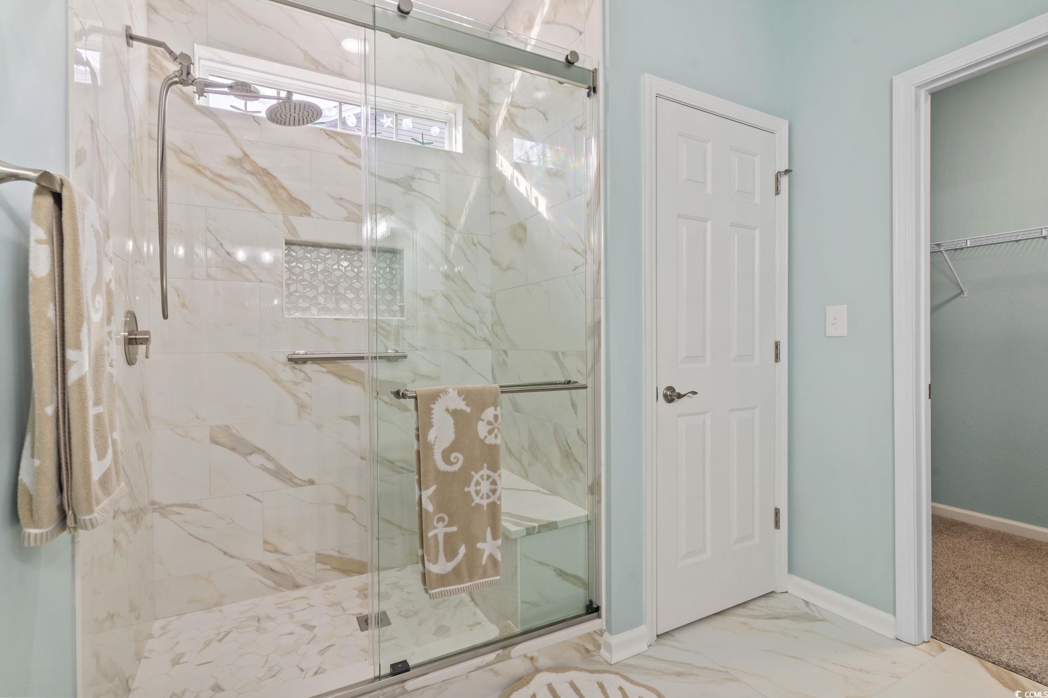 430 Woodpecker Lane, Unit D Murrells Inlet, SC 29576 - Photo 21 of 36 Bathroom with a marble finish shower, marble look tiles, and a walk in closet
