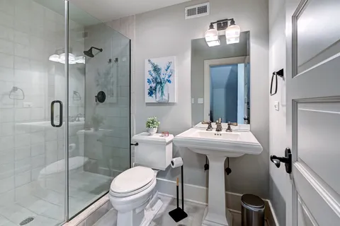 a bathroom with a sink toilet and shower