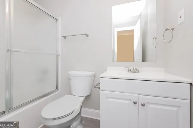 a white toilet sitting next to a bathroom sink