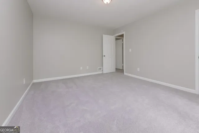 a view of an empty room and entryway