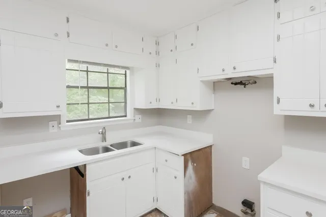 a kitchen with a sink cabinets and window