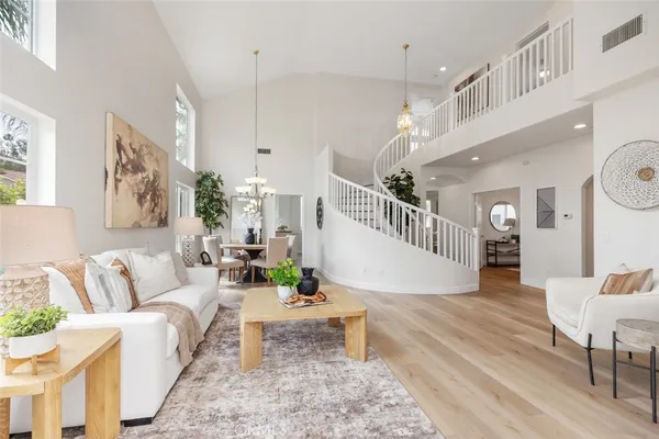 a living room with furniture and a dining table